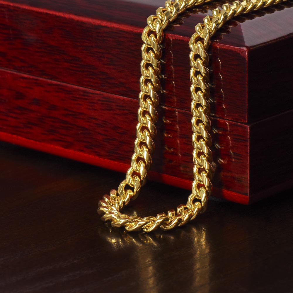 Gold finish Cuban chain draped over the mahogany Luxury Box | Cuban Link Chain