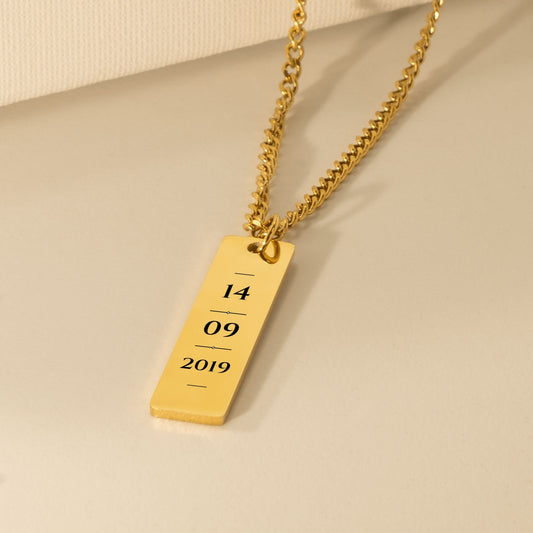 Gold vertical bar engraved with a sample date, 14 09 2019, on a Cuban chain