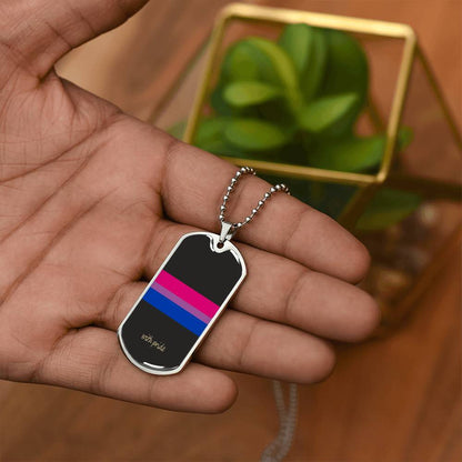Bi pride stripe dog tag in the palm beside a plant | Subtle Bi Pride Dog Tag