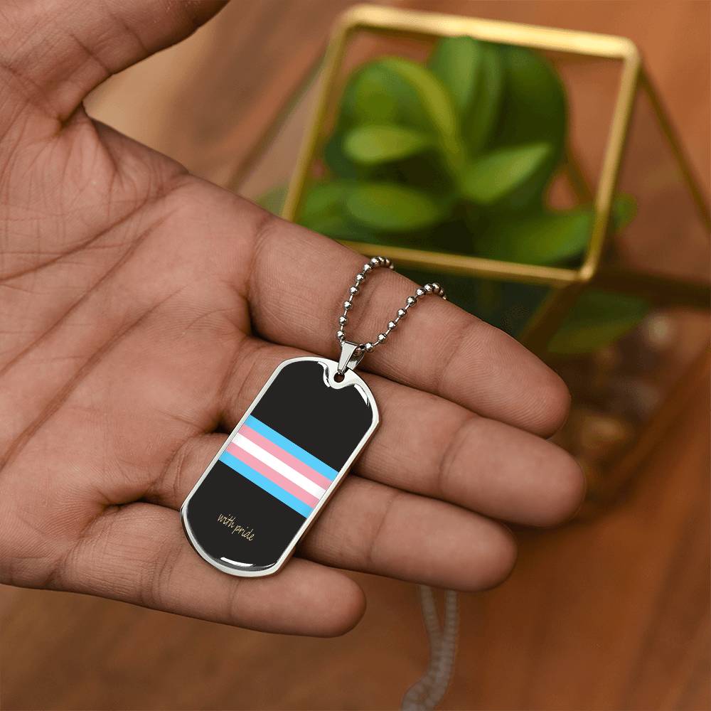 Trans pride stripe dog tag in the palm beside a plant | Subtle Trans Pride Dog Tag