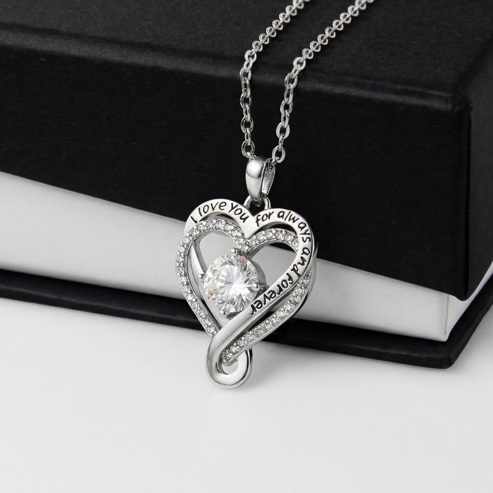 Ribbon heart pendant resting on an open black gift box | Love You Always Necklace
