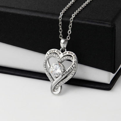 Ribbon heart pendant resting on an open black gift box | Love You Always Necklace