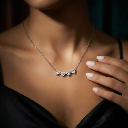 Woman in a black top wearing the hearts opened in a row | Magnetic Hearts Necklace