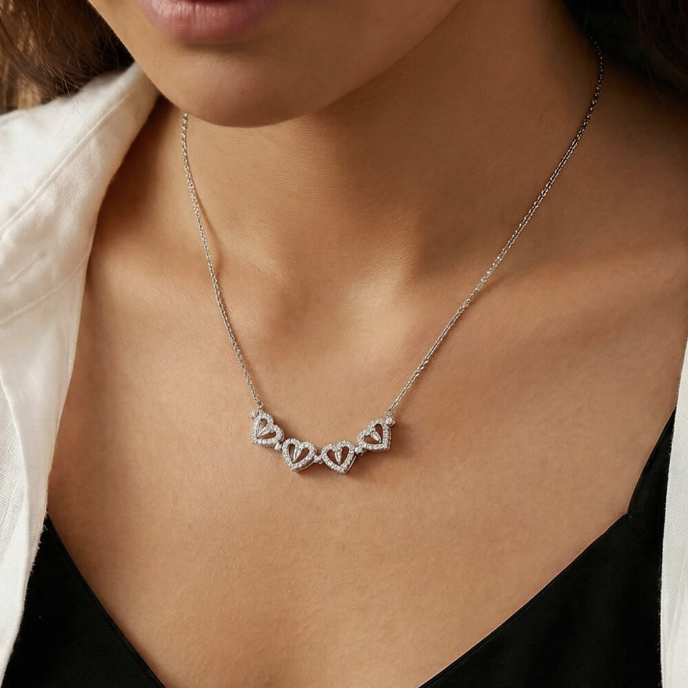 Row of hearts worn with a black top, close view | Magnetic Hearts Necklace