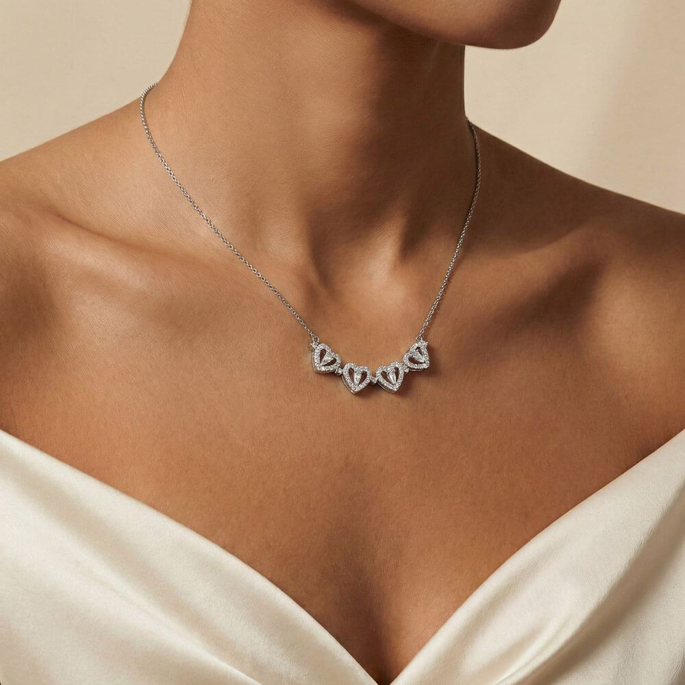 Row of four hearts worn with a white top | Magnetic Hearts Necklace