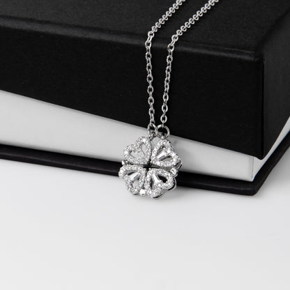 Clover pendant draped over a black gift box | Magnetic Hearts Necklace