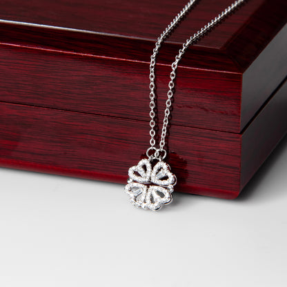 Clover pendant draped over the mahogany Luxury Box | Magnetic Hearts Necklace