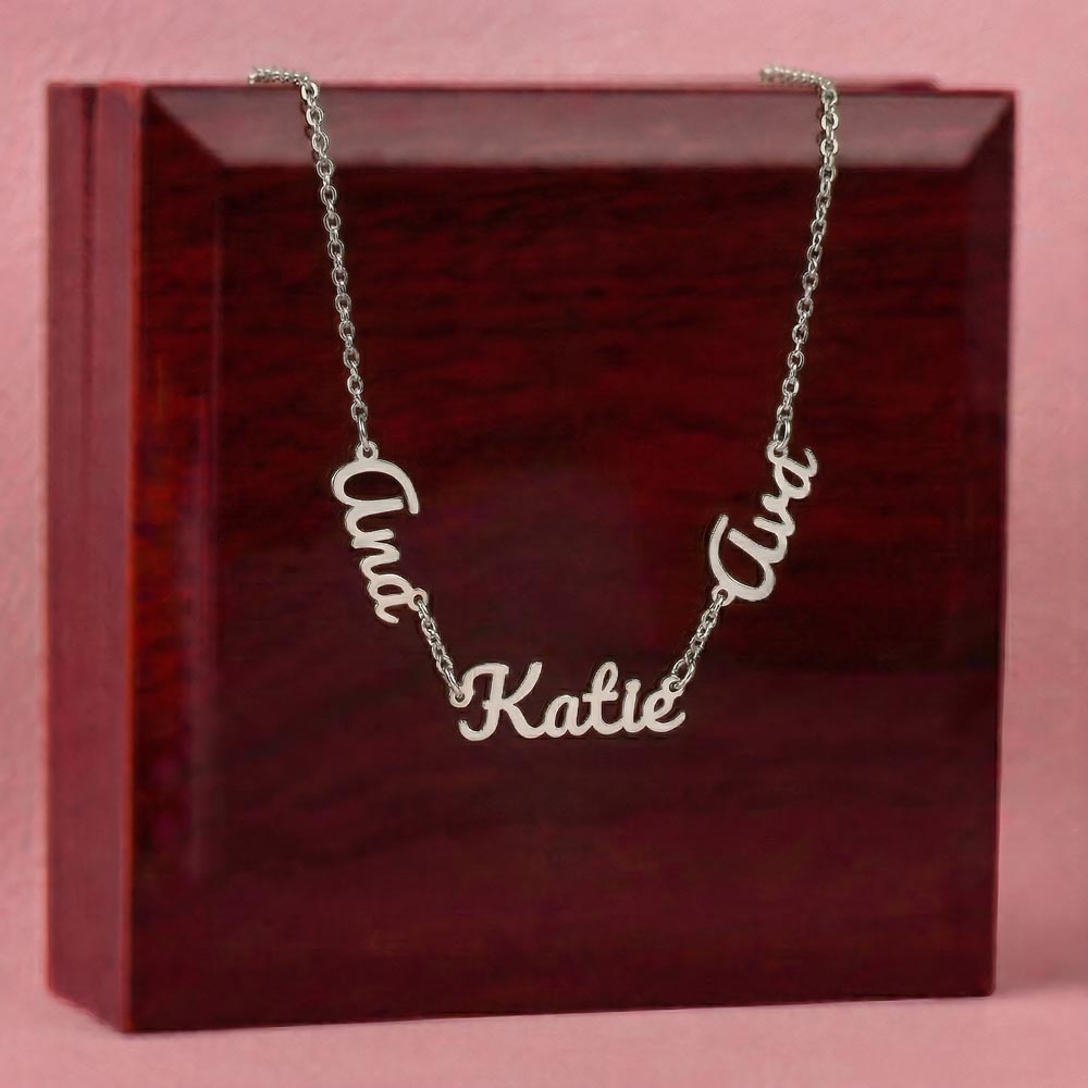 Steel three-name necklace draped over the mahogany Luxury Box | Multiple Name Necklace