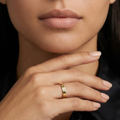 Gold finish engraved ring worn, hand at her chin | Engraved Women's Ring