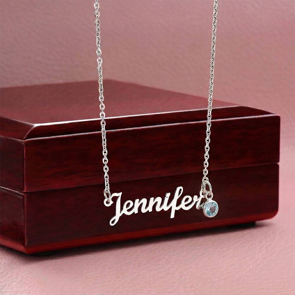 Steel name necklace with birthstone draped over the mahogany Luxury Box | Name Necklace with Birthstone