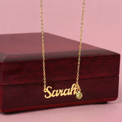 Gold finish name necklace with birthstone draped over the mahogany Luxury Box | Name Necklace with Birthstone