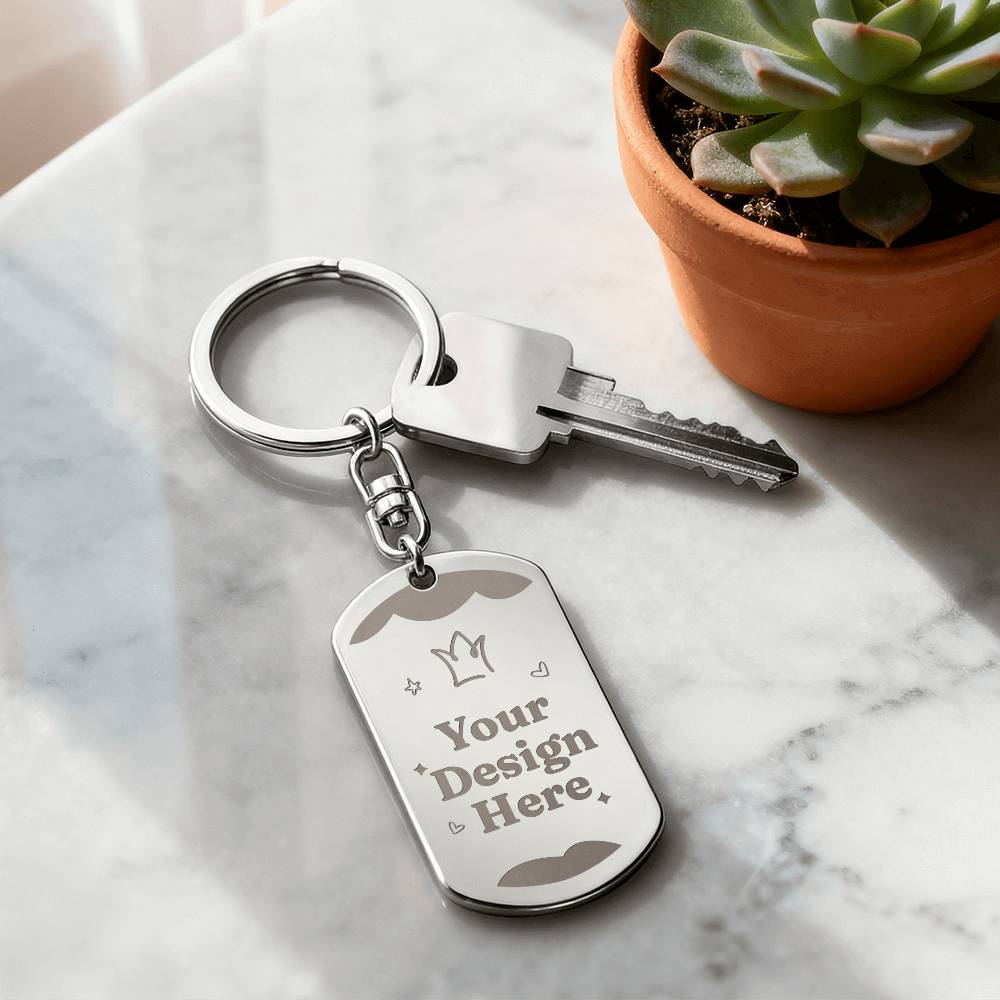 Steel dog tag keychain on a marble surface beside a plant | Engraved Dog Tag Keychain