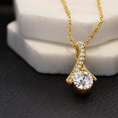Yellow gold finish pendant on a white stone block, close view | Proud Mom Necklace