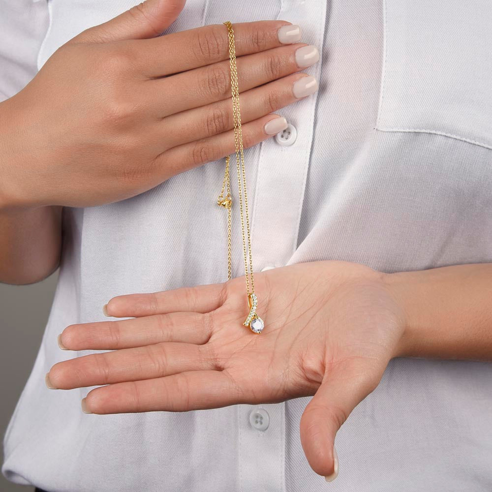Open hand holding the yellow gold finish pendant and chain | Proud Mom Necklace
