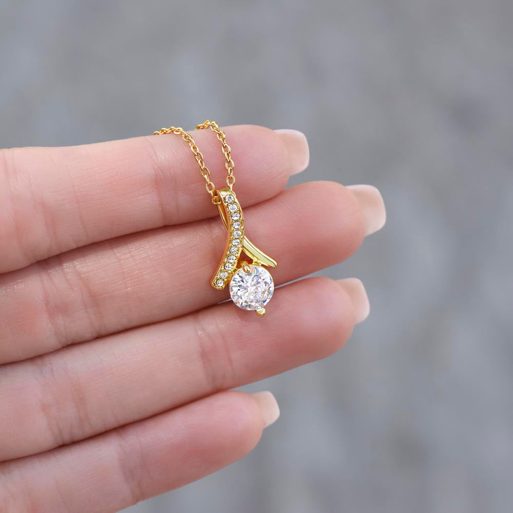 Fingers holding up the yellow gold finish pendant | Proud Mom Necklace
