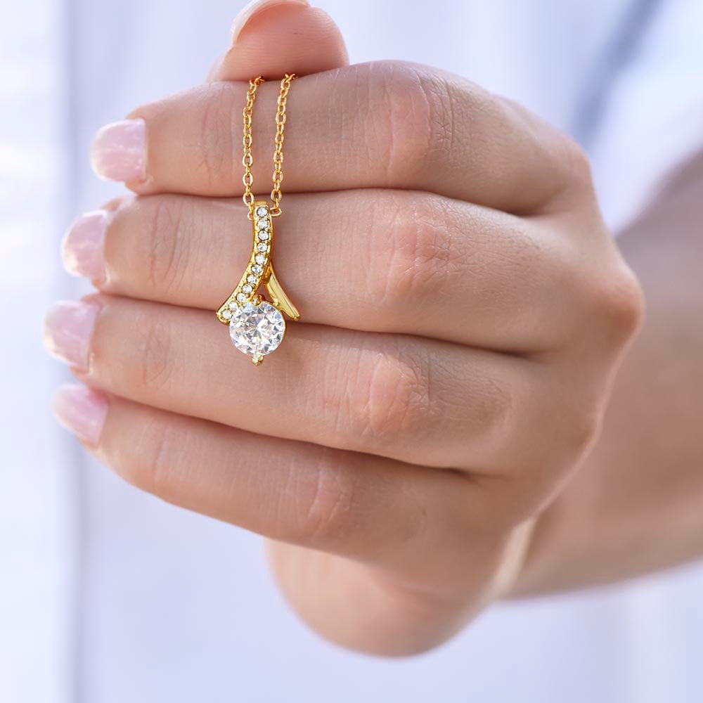 Hand holding the yellow gold finish pendant by its chain | Proud Mom Necklace