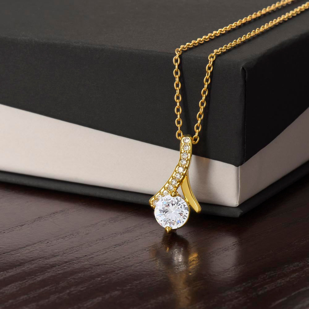 Yellow gold finish pendant draped over a black gift box | Proud Mom Necklace