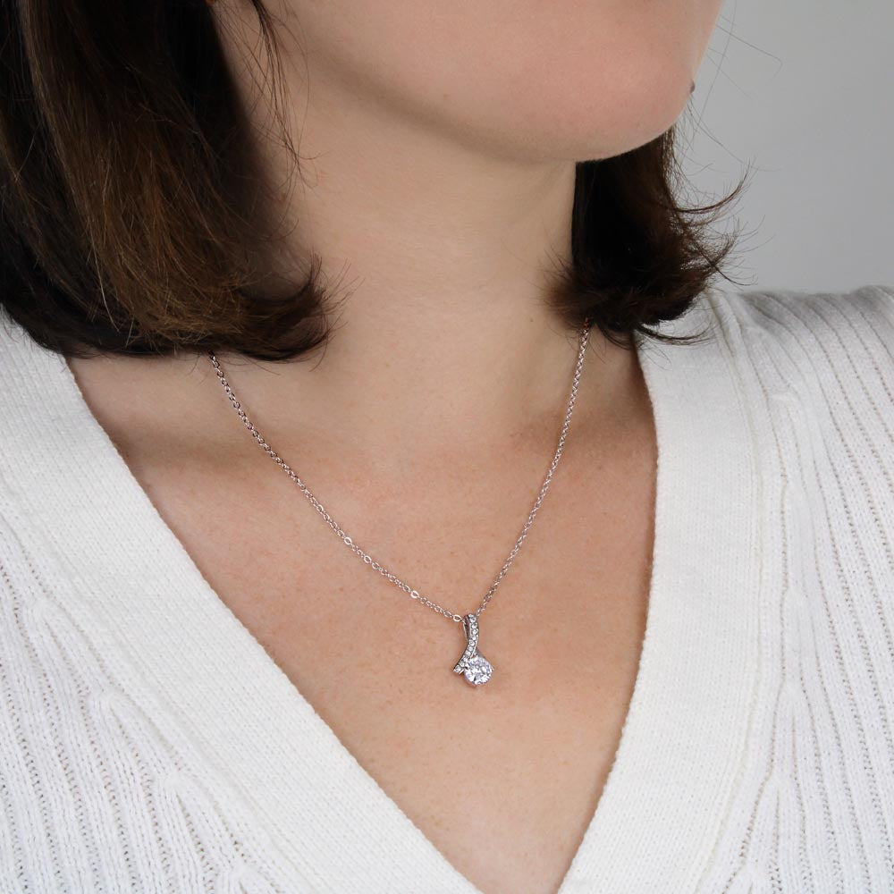 Woman in a white sweater wearing the white gold finish pendant | Proud Mom Necklace