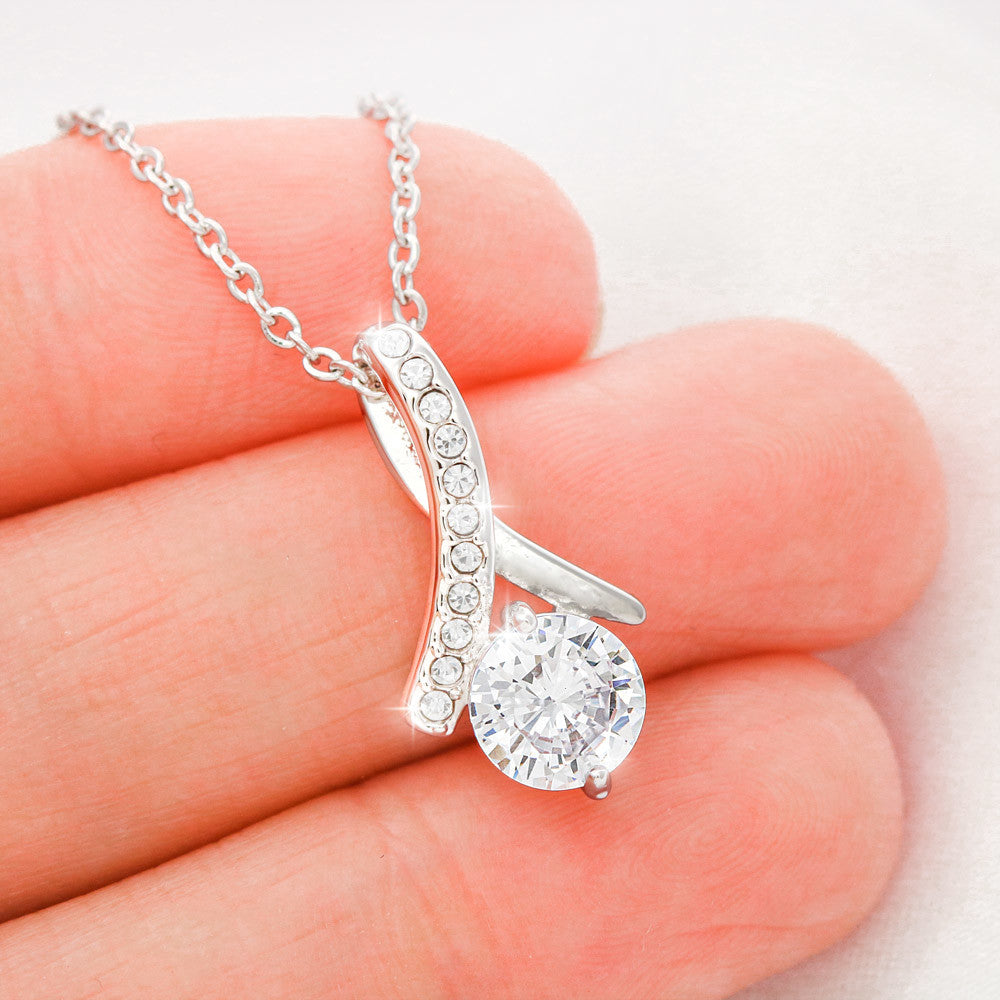 White gold finish pendant held between two fingers | Proud Mom Necklace