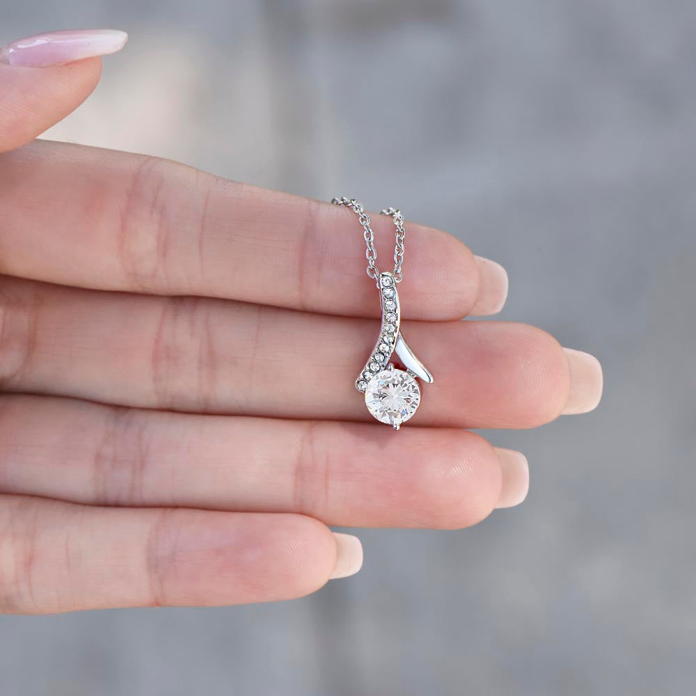 Fingers holding up the white gold finish pendant | Proud Mom Necklace