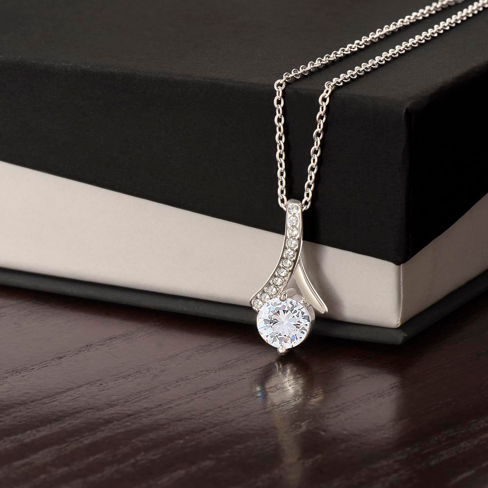White gold finish pendant draped over a black gift box | Proud Mom Necklace