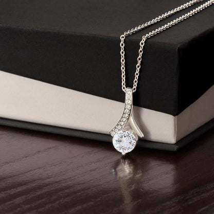 White gold finish pendant draped over a black gift box | Proud Mom Necklace