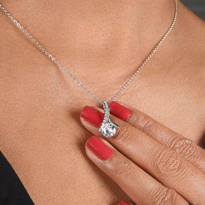 Woman with red nails holding the white gold finish pendant at her neckline | Proud Mom Necklace
