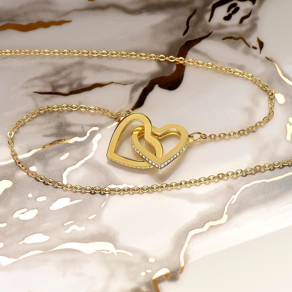 Yellow gold finish interlocking hearts on white and gold marble | Always Proud, Always Loved Necklace