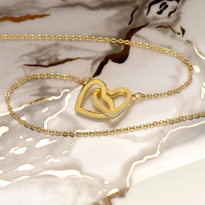 Yellow gold finish interlocking hearts on white and gold marble | Always Proud, Always Loved Necklace