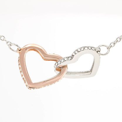 Steel and rose gold interlocking hearts on a white background | Always Proud, Always Loved Necklace
