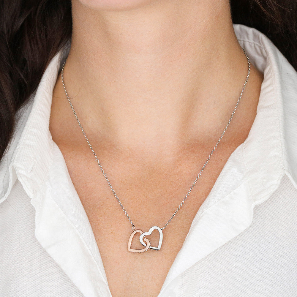 Interlocking hearts worn with a white shirt | Always Proud, Always Loved Necklace