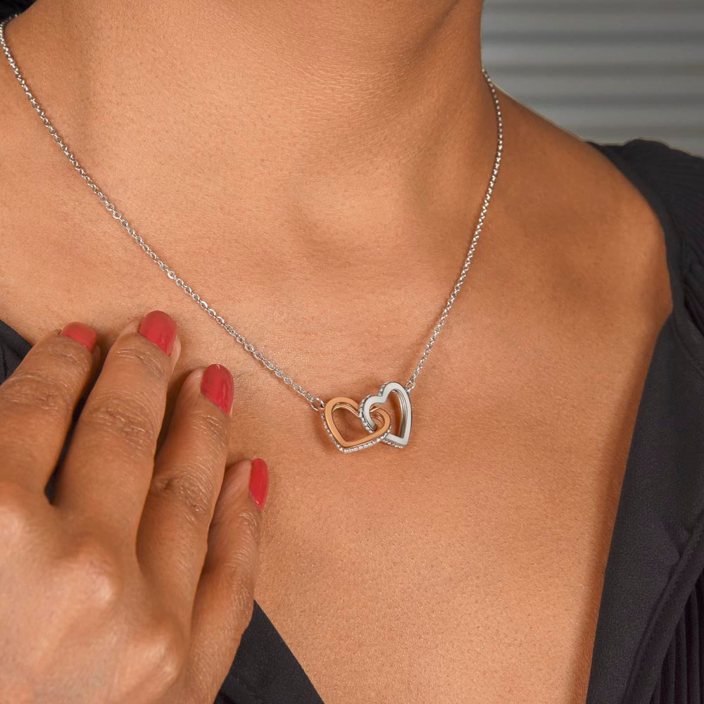 Interlocking hearts pendant worn with a black top | Always Proud, Always Loved Necklace