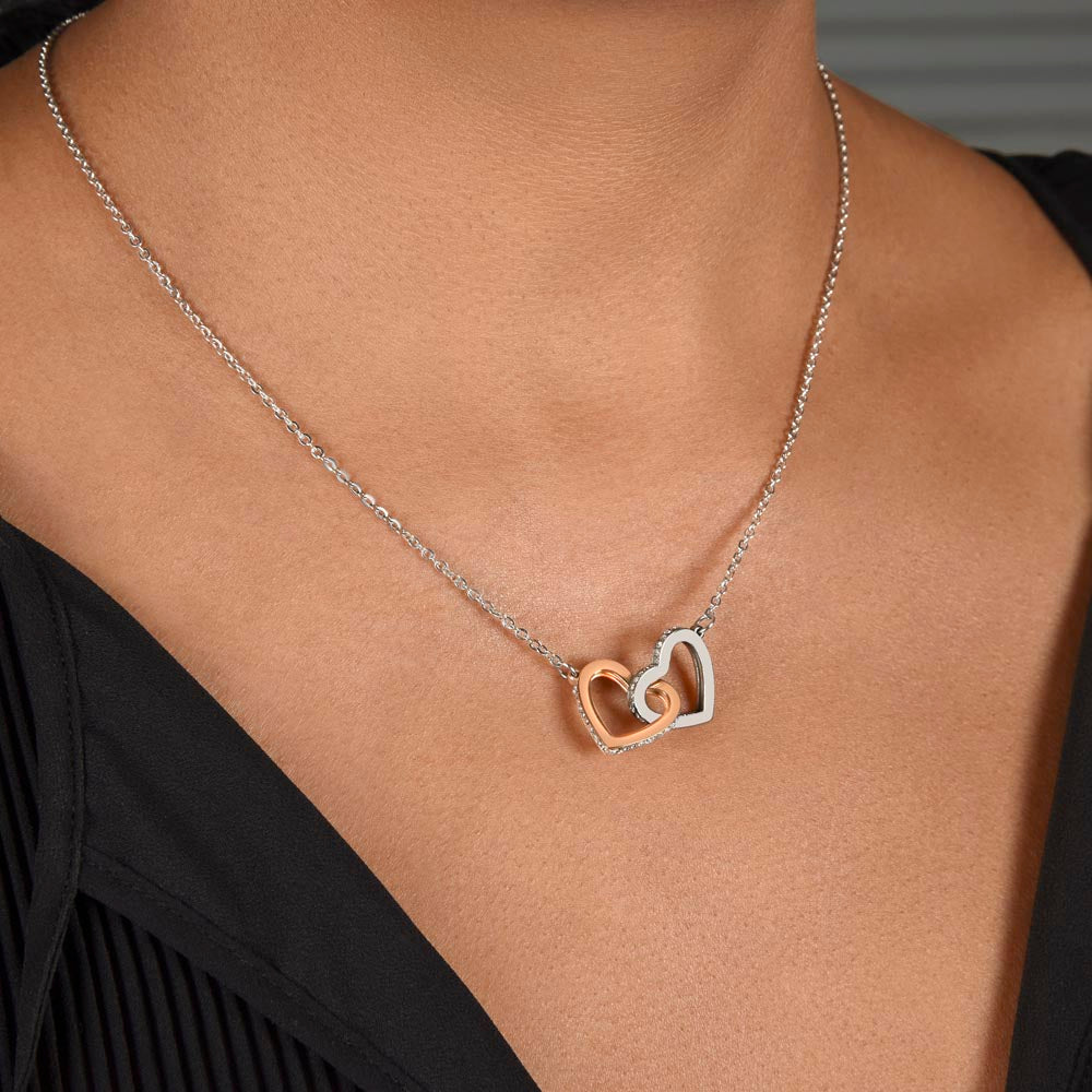 Steel and rose gold interlocking hearts worn with a black top | Always Proud, Always Loved Necklace