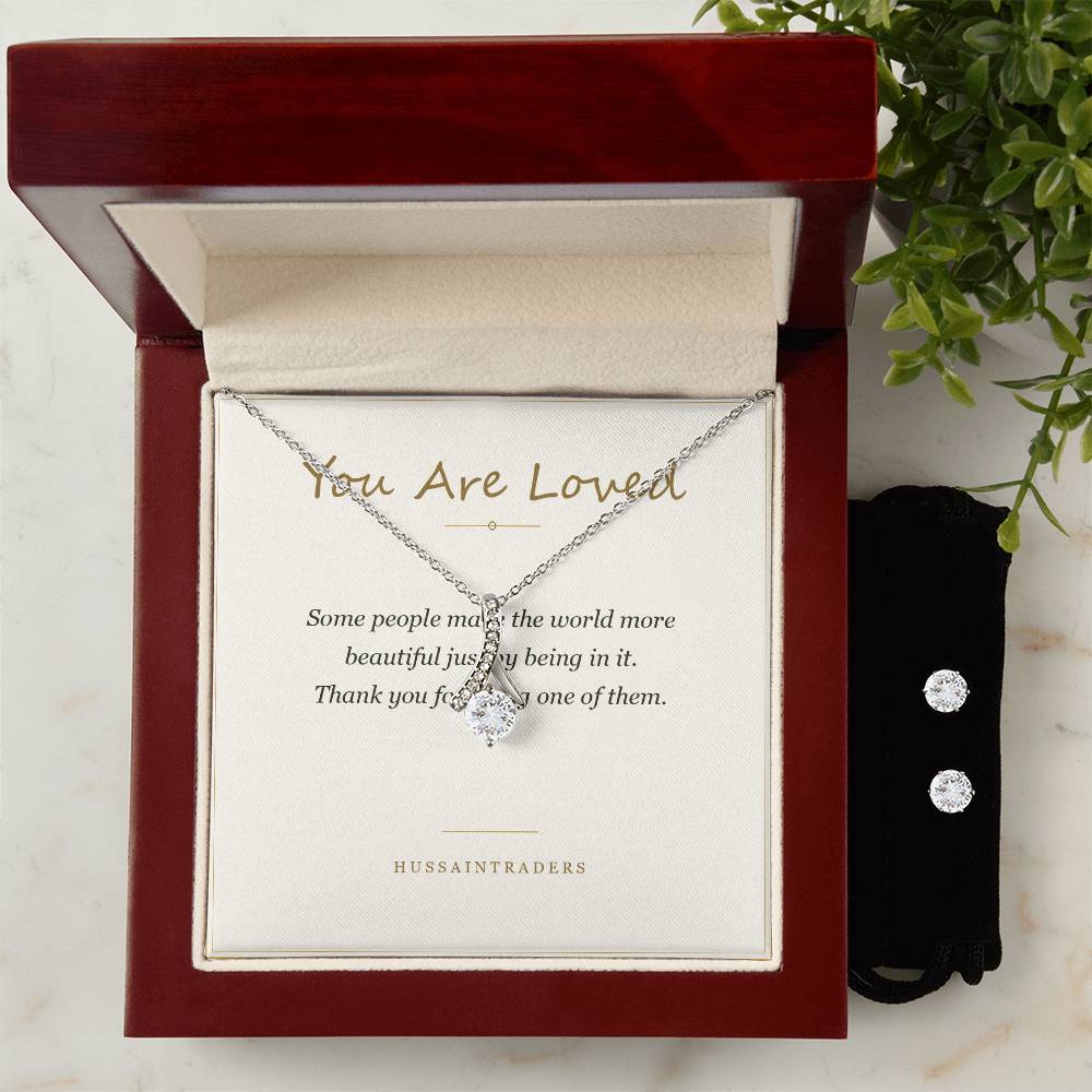 Alluring Beauty set in the mahogany Luxury Box beside greenery | Alluring Beauty Necklace and Earring Set
