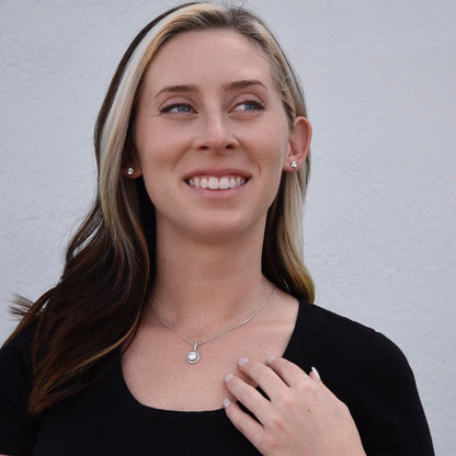 Smiling woman touching the Eternal Hope pendant | Eternal Hope Necklace and Earring Set