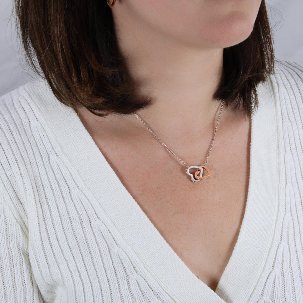 Woman in a white top wearing the interlocking hearts | Interlocking Hearts Necklace