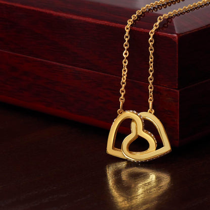 Yellow gold finish hearts draped over the mahogany Luxury Box | Interlocking Hearts Necklace