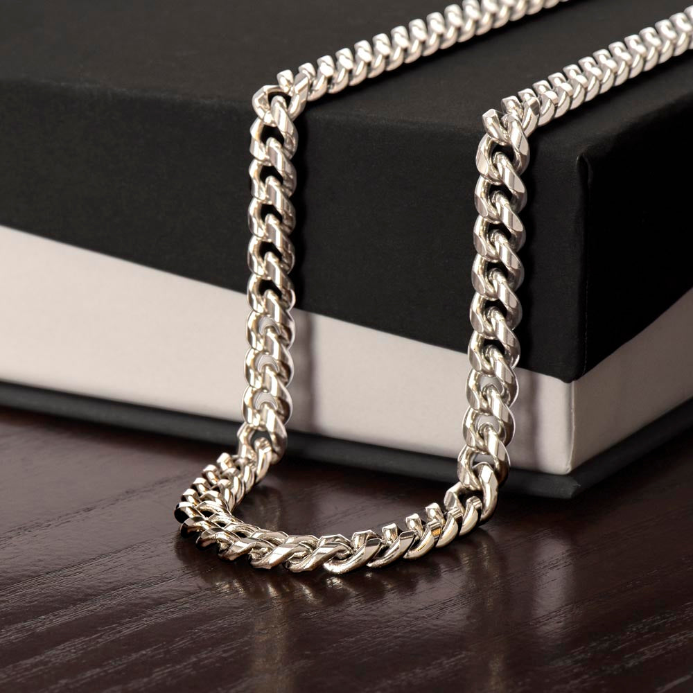 Polished steel Cuban link chain draped over a black gift box | Cuban Link Chain