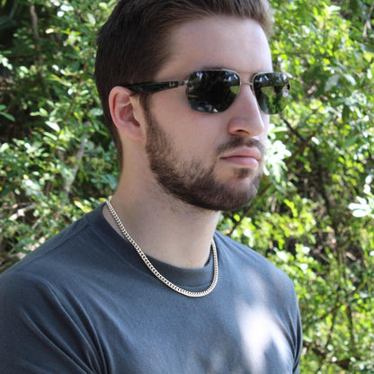 Man in sunglasses wearing the steel Cuban chain outdoors | Cuban Link Chain