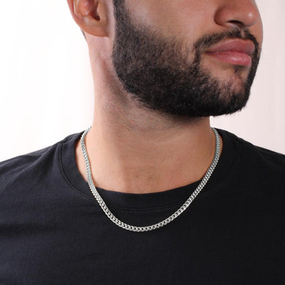Steel Cuban chain worn with a black tee, close view | Cuban Link Chain