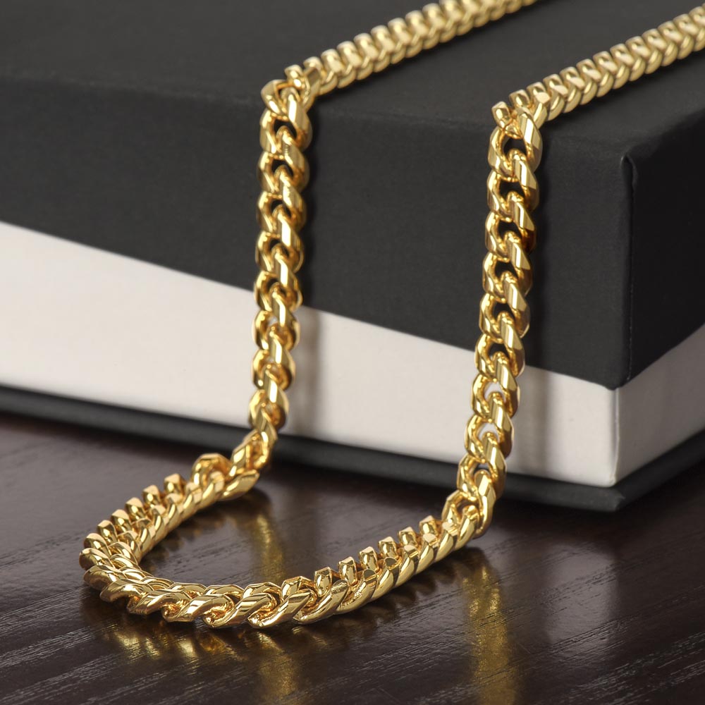 18k yellow gold finish Cuban link chain draped over a black gift box | Cuban Link Chain