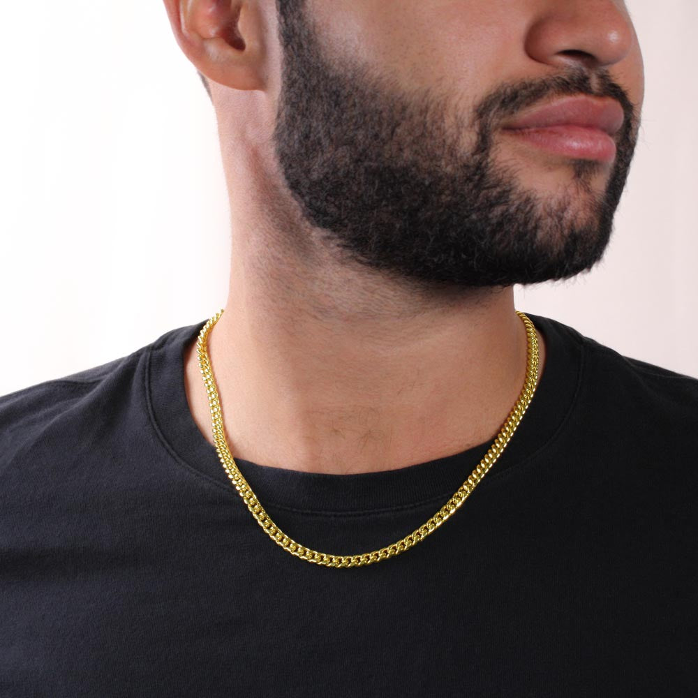 Gold finish Cuban chain worn with a black tee, close view | Cuban Link Chain