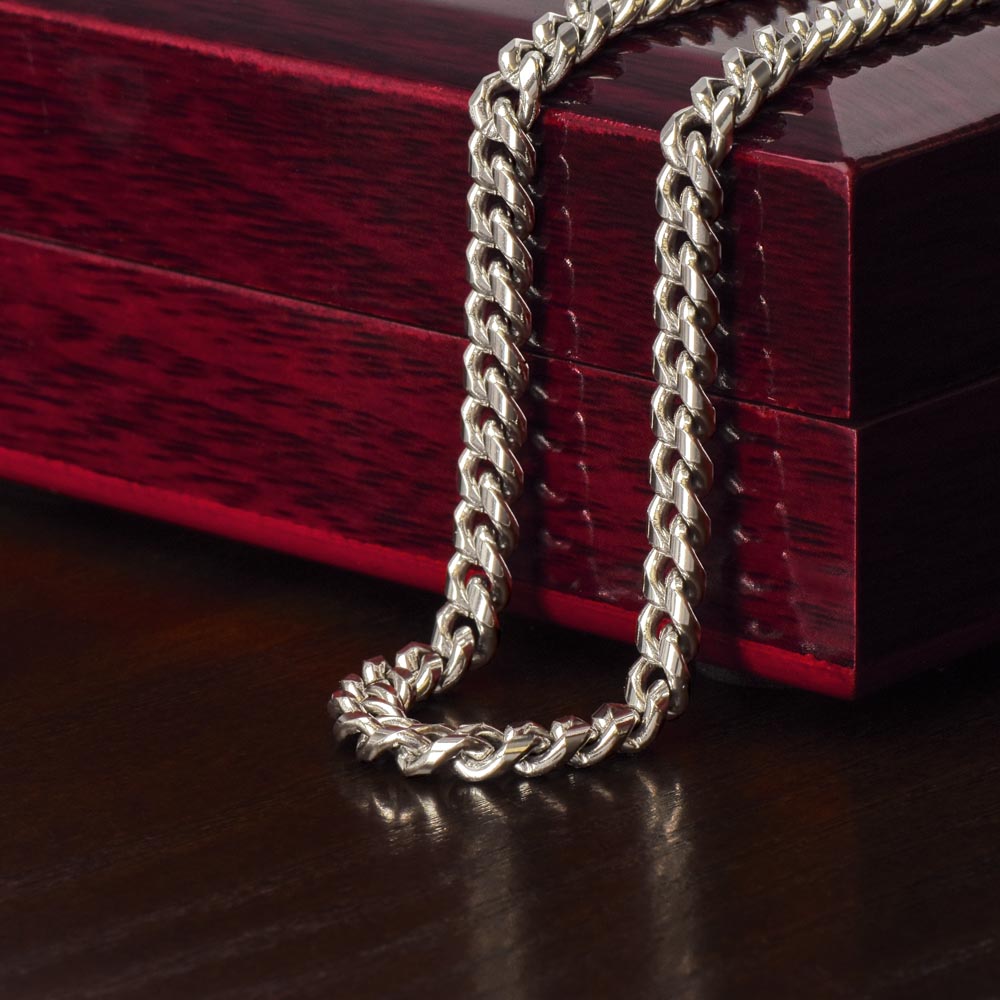 Steel Cuban chain draped over the mahogany Luxury Box | Cuban Link Chain