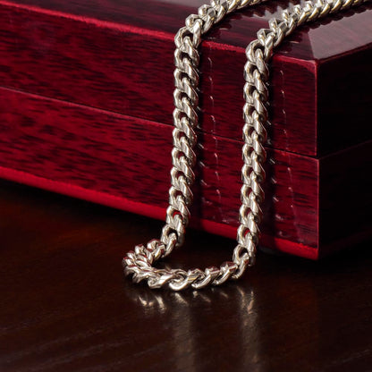 Steel Cuban chain draped over the mahogany Luxury Box | Cuban Link Chain