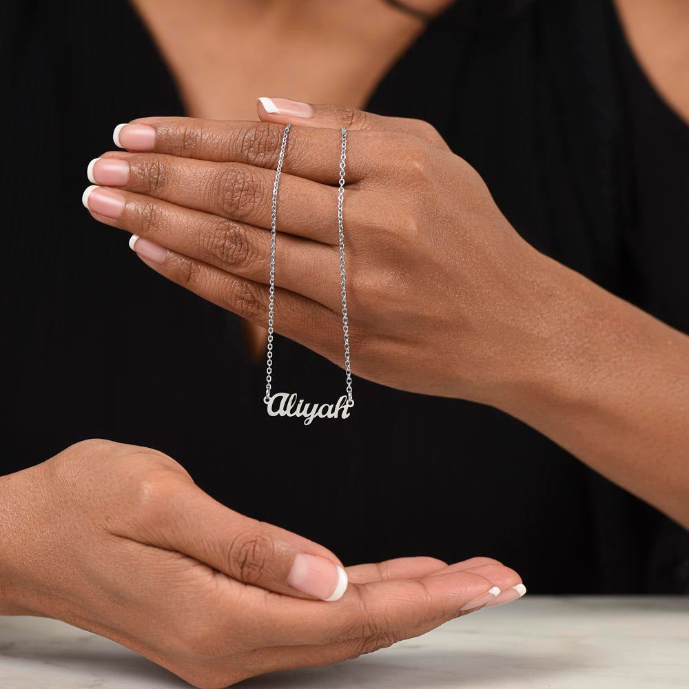 Silver name necklace draped over the fingers | Chosen Name Necklace