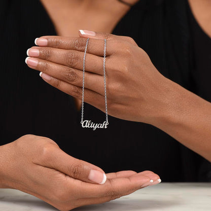 Silver name necklace draped over the fingers | Chosen Name Necklace
