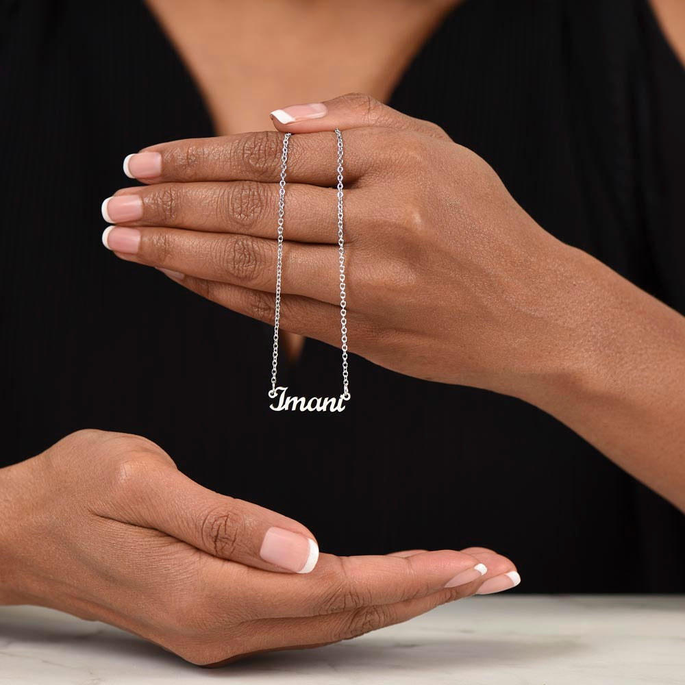 Silver name necklace draped over the hand | Chosen Name Necklace