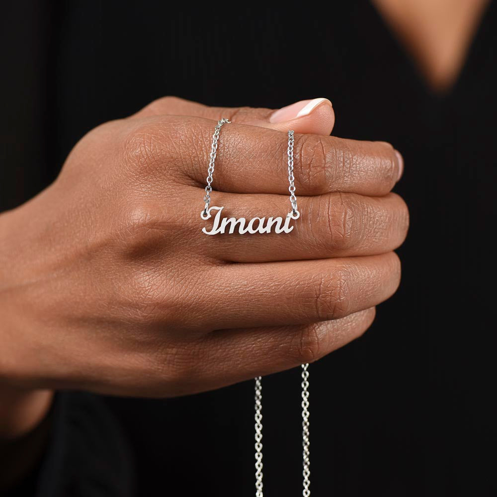 Silver name necklace held in the hand | Chosen Name Necklace