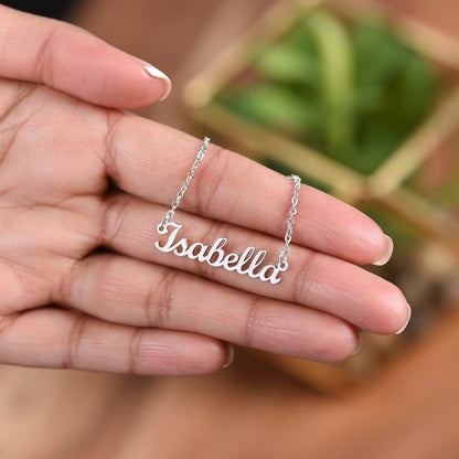 Silver name necklace held over a plant | Chosen Name Necklace