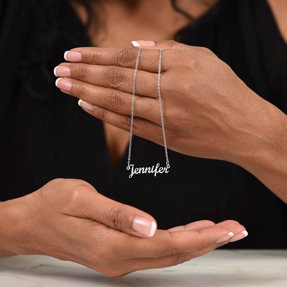 Silver name necklace draped over the hand | Chosen Name Necklace